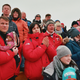 Spectators cheer on the mushers at the finish line.